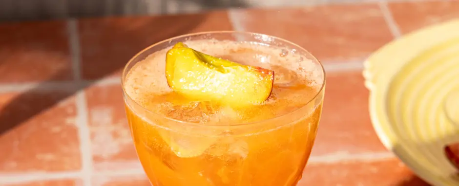 A photograph of the Peach Aperol Spritz cocktail