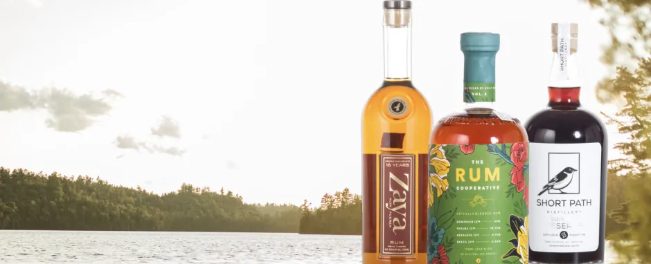 3 bottles of spirits with a landscape background