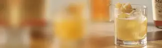 Ginger and mint cocktail on blurred background