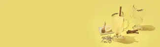Yellow background with hot toddy's, lemons, honey, and cinnamon sticks