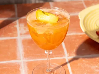 A photograph of the Peach Aperol Spritz cocktail