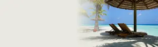 2 empty deck chairs on a beach overlooking the ocean.