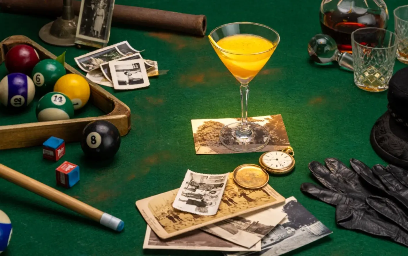 a yellow cocktail on a pool table