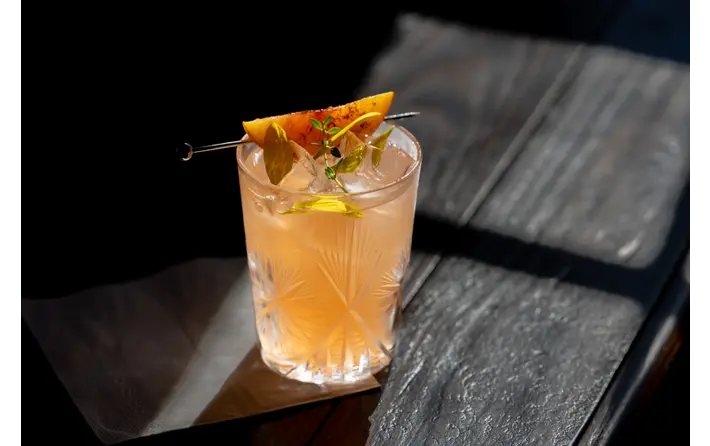 Summer Peach cocktail with grilled peach garnish. Recipe by Ethan Guillemette.